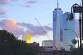 A building reflects golden sunset backed by a radiant sky, NYC, NY