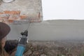Building renovation. Removing red brick from the foundation. Royalty Free Stock Photo