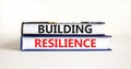 Building resilience symbol. Concept word Building resilience typed on books. Beautiful white table white background. Business and Royalty Free Stock Photo