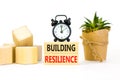 Building resilience symbol. Concept word Building resilience typed on wooden blocks. Beautiful white table white background. Black Royalty Free Stock Photo