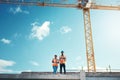 Building roof, engineer team talking at construction site outdoor for vision, development or architecture. Black woman Royalty Free Stock Photo