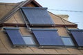 Building roof with rows of vacuum air solar collectors for water heating and producing of clean ecological energy Royalty Free Stock Photo