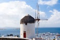 Building with sail and straw roof in Mykonos, Greece. Windmill on mountain landscape on sky. Whitewashed windmill at sea Royalty Free Stock Photo