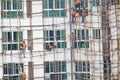 Building scaffolding in mumbai maharashtra ,India .workers standing and working safely with orange safety jacket and rope tied on