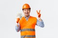 Building sector and industrial workers concept. Happy smiling asian builder, construction manager in helmet and