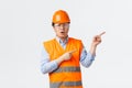 Building sector and industrial workers concept. Impressed and amazed asian construction manager, engineer in helmet and