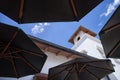 Building seen through patio umbrellas