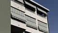 Building with a series of balconies with striped awnings Italy, Europe Royalty Free Stock Photo