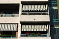 Building with a series of balconies with striped awnings Italy, Europe Royalty Free Stock Photo