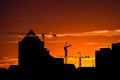 Building silhouettes and cranes at sunset Royalty Free Stock Photo