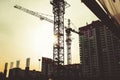 Building site with high-rise block under construction in an urban environment dominated by a large industrial crane Royalty Free Stock Photo