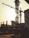 Building site with high-rise block under construction in an urban environment dominated by a large industrial crane Royalty Free Stock Photo