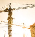 Building site with high-rise block under construction in an urban environment dominated by a large industrial crane Royalty Free Stock Photo