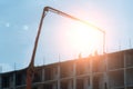 Building site with high-rise block under construction in an urban environment dominated by a large industrial crane Royalty Free Stock Photo