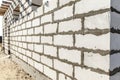 Building site of a house under construction. corner unfinished house walls made from white aerated autoclaved concrete blocks