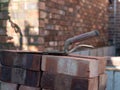 Building site: trowel, bricks and mortar for brickwork, part of a renovation of an Edwardian suburban house in north London, UK