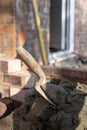 Building site: trowel, bricks and mortar for brickwork, part of a renovation of an Edwardian suburban house in north London, UK