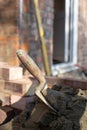 Building site: trowel, bricks and mortar for brickwork, part of a renovation of an Edwardian suburban house in north London, UK