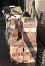 Building site: trowel, bricks and mortar for brickwork, part of a renovation of an Edwardian suburban house in north London, UK