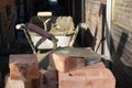 Building site: trowel, bricks and mortar for brickwork, part of a renovation of an Edwardian suburban house in north London, UK Royalty Free Stock Photo