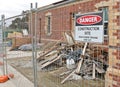 Building site under construction with warning sign and piles of rubble Royalty Free Stock Photo