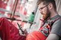 Building site worker on the scaffolding using mobile phone Royalty Free Stock Photo