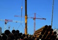 Building site with working lift cranes on a sunny day with clear blue sky Royalty Free Stock Photo