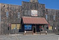 a building sitting in the middle of a parking lot next to the mountains