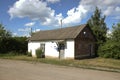 Building of small post office of Russian post among rural landscape.