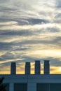 A Building with smokestacks against dramatic sky