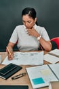 Building a successful business with utmost dedication. a young architect working with blueprints in an office. Royalty Free Stock Photo