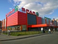 Building Supermarket SPAR. Retail industry. Modern facade in red. Cityscape. Bankruptcy concept. City street. Real life. Blue sky