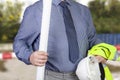 Building surveyor carrying hi vi vis vest and hard hat Royalty Free Stock Photo