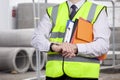 Building surveyor in high visibility checking the time on site Royalty Free Stock Photo