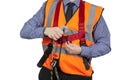 Building Surveyor in orange visibility vest attaching lanyard to Royalty Free Stock Photo