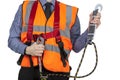 Building Surveyor in orange visibility vest securing safety harness lanyard