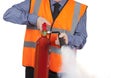 Building Surveyor in orange visibility vest using a fire extinguisher Royalty Free Stock Photo