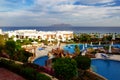 The building and swimming pools are near beach of luxury hotel