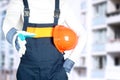 Building, teamwork, partnership, gesture and people concept - close up of builder in gloves greeting someone on construction site