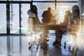 Building their empire from the ground up. Shot of a team of brainstorming businesspeople double exposed with an image of Royalty Free Stock Photo