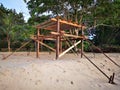 Building a tiny wooden house on the beach side.