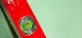 Building tool level. Red water level tool isolated on green background. Concept. Copy space Royalty Free Stock Photo