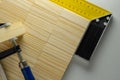 Corner Ruler and clamp with wooden blocks background