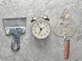 Building tools on a gray concrete background. Spatula, trowel, alarm clock, top view. Royalty Free Stock Photo