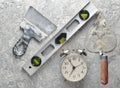 Building tools on a gray concrete background. Spatula, trowel, level, alarm clock, level, top view. Royalty Free Stock Photo