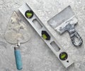 Building tools on a gray concrete background. Spatula, trowel, level, level, top view. Royalty Free Stock Photo
