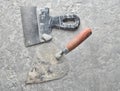 Building tools on a gray concrete background. Spatula, trowel, top view. Royalty Free Stock Photo