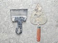 Building tools on a gray concrete background. Spatula, trowel, top view. Royalty Free Stock Photo