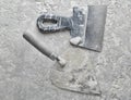 Building tools on a gray concrete background. Spatula, trowel, top view. Royalty Free Stock Photo