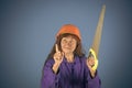 Building tools. Old lady with saw on blue background